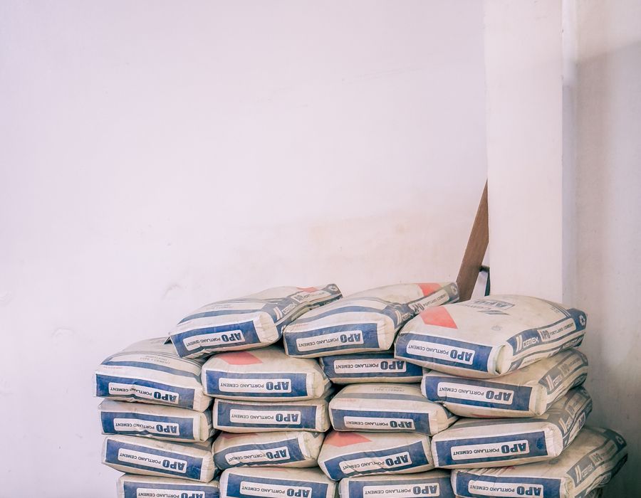 Illustrative stock photo: Cement bags stacked indoors.